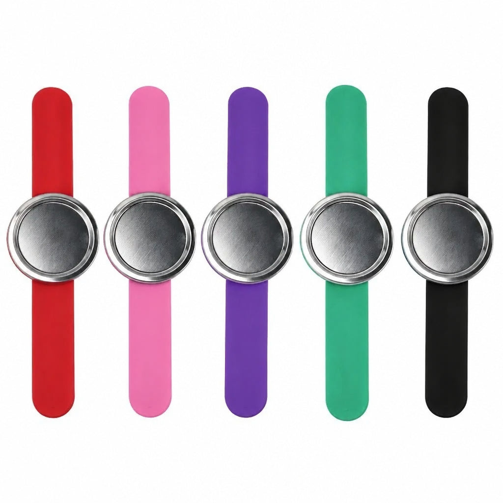 Five silicone wristbands in red, orange, purple, green, and blue, each with a brushed silver metal circular clasp, arranged in a row on a white background.