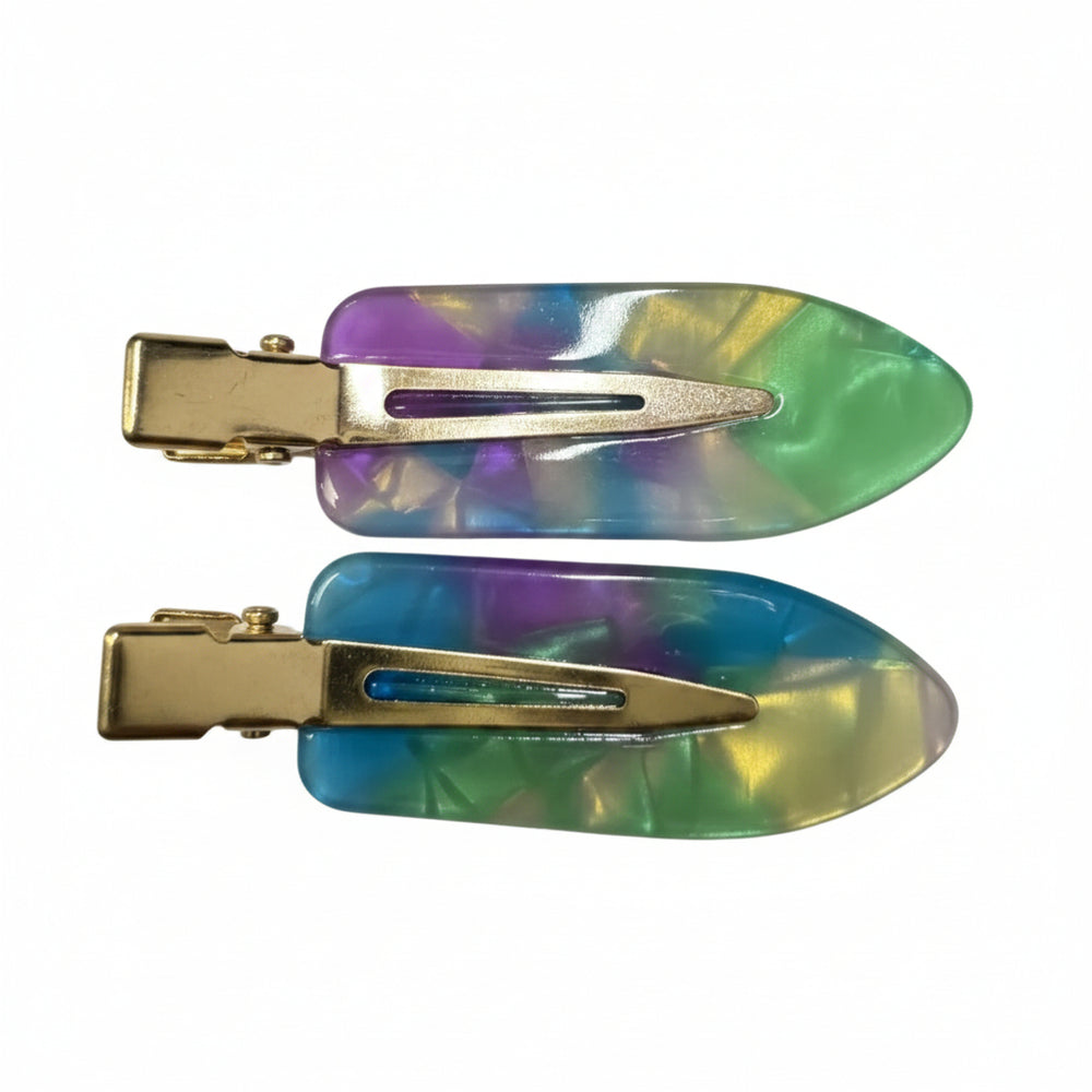 Two hair claw clips with iridescent resin hairpieces in green, blue, purple, and yellow tones, attached to gold-tone metal clips, shown on a plain white background.