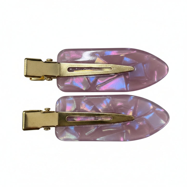 Two hair claw clips with iridescent lavender-pink resin inserts and gold-tone metal clasps, shown on a plain white background.
