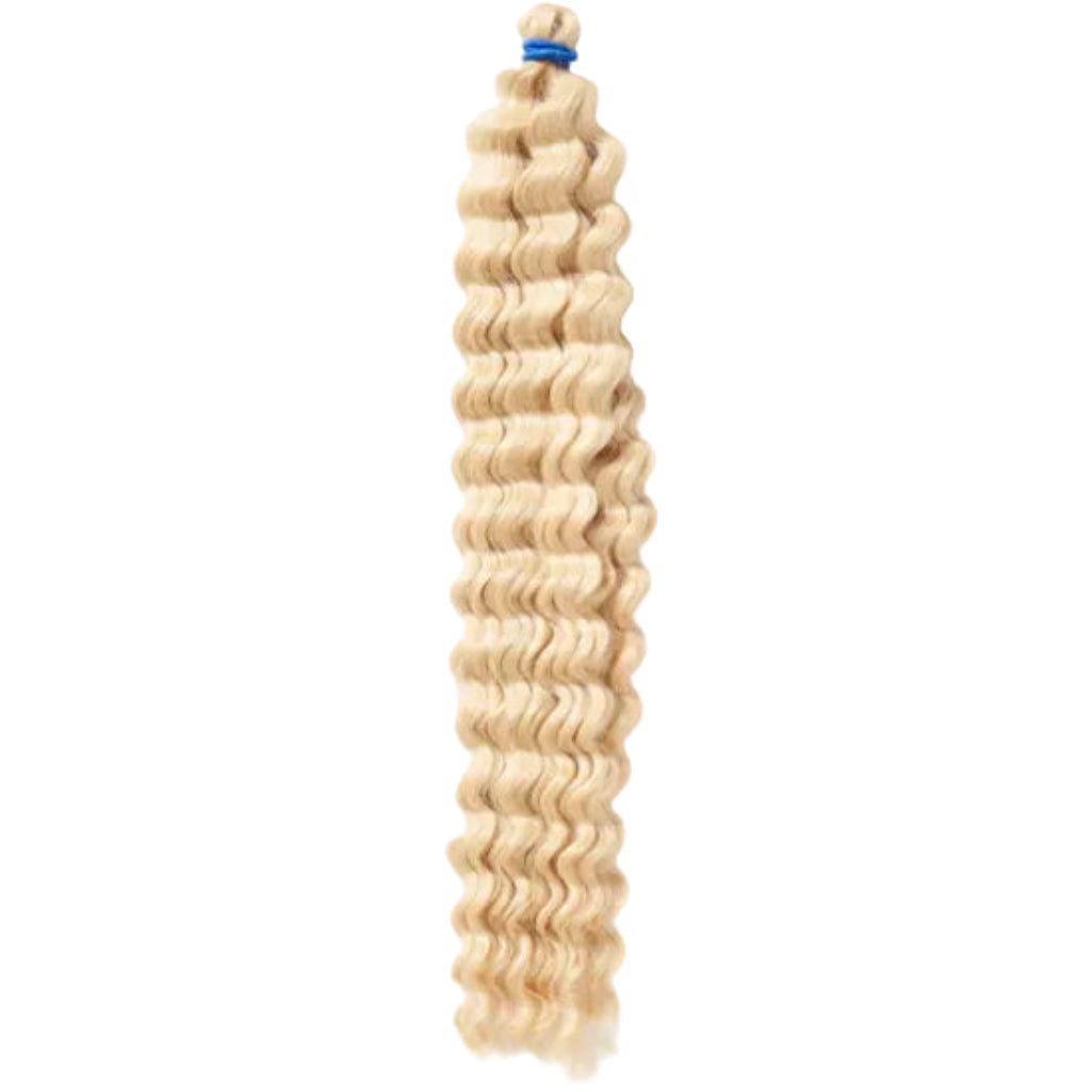 A packaged synthetic hair extension with a curly texture, branded &