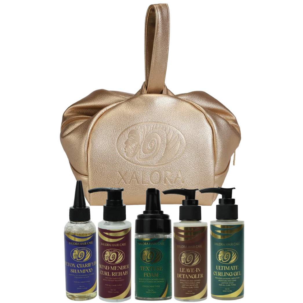 Set of hair care products with a gold bag on a white background
