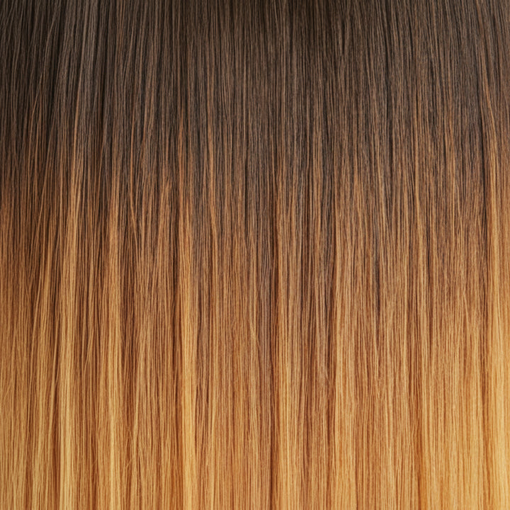 Close-up of straight hair showing a dark brown to warm golden-brown ombré color transition.